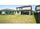 View of the backyard with pond, patio with furniture, and grill at 14623 Horse Trot Rd, Lithia, FL 33547