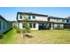 Landscaped backyard and house with pond, lawn and patio at 14623 Horse Trot Rd, Lithia, FL 33547
