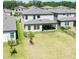 A well-maintained backyard with lush green grass and a covered patio area, perfect for outdoor entertaining and relaxation at 14623 Horse Trot Rd, Lithia, FL 33547