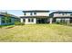 View of the landscaped backyard with pond, patio with furniture, and house at 14623 Horse Trot Rd, Lithia, FL 33547