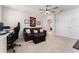 Comfortable bedroom space with a ceiling fan, leather couch and desk, plus neutral-toned walls and carpet at 14623 Horse Trot Rd, Lithia, FL 33547