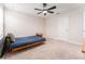 Neutral toned bedroom with a ceiling fan, light-colored walls, and a simple bed and desk space at 14623 Horse Trot Rd, Lithia, FL 33547