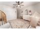 Bright Bedroom with a wooden crib, plush rug, tent, changing table and neutral walls, creating a peaceful space at 14623 Horse Trot Rd, Lithia, FL 33547