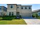 Charming two-story home features a paver driveway, manicured lawn, and attached two-car garage at 14623 Horse Trot Rd, Lithia, FL 33547