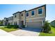 Exterior of the home with a two-car garage, manicured lawn, and beautiful landscaping at 14623 Horse Trot Rd, Lithia, FL 33547