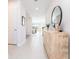 Bright and airy hallway with neutral tile flooring and decorative console table at 14623 Horse Trot Rd, Lithia, FL 33547