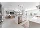 Open concept kitchen and living room with stainless appliances, a central island, and comfortable seating with a view at 14623 Horse Trot Rd, Lithia, FL 33547