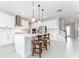 Beautiful kitchen features white cabinets, a central island with seating, and modern stainless-steel appliances for cooking at 14623 Horse Trot Rd, Lithia, FL 33547