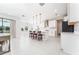 Open-concept kitchen features modern white cabinets, a central island with seating, and sleek appliances for culinary enjoyment at 14623 Horse Trot Rd, Lithia, FL 33547