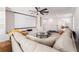 Comfortable living room with large sectional sofa, ceiling fan and projector with a blank screen at 14623 Horse Trot Rd, Lithia, FL 33547