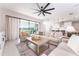 Relaxing living room offers a ceiling fan, comfortable seating, and large windows with a view of the outdoors at 14623 Horse Trot Rd, Lithia, FL 33547