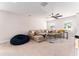 Spacious living room with sofa, beanbag chair and ceiling fan at 14623 Horse Trot Rd, Lithia, FL 33547