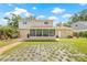 Expansive backyard with brick walkway leading to the home and the screened-in porch at 15034 Newport Rd, Clearwater, FL 33764