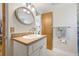 Bathroom featuring a vanity, mirror, and wooden doors, providing a classic touch at 15034 Newport Rd, Clearwater, FL 33764