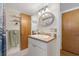 Bathroom with a vanity, mirror, and two doors, ensuring functionality and style at 15034 Newport Rd, Clearwater, FL 33764