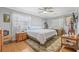Cozy bedroom with hardwood floors, ceiling fan and two windows for natural light at 15034 Newport Rd, Clearwater, FL 33764
