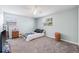 Carpeted bedroom featuring a bed, dresser and plenty of natural light at 15034 Newport Rd, Clearwater, FL 33764