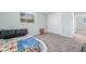 This bedroom features gray carpeting, a window and an adjacent closet at 15034 Newport Rd, Clearwater, FL 33764