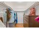 Walk-in closet with wooden floors and a built-in drawer for efficient storage at 15034 Newport Rd, Clearwater, FL 33764