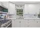 Well-appointed kitchen with stone countertops, modern appliances, and ample cabinet space at 15034 Newport Rd, Clearwater, FL 33764