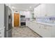 Updated kitchen with stainless steel appliances, white cabinetry, and decorative backsplash at 15034 Newport Rd, Clearwater, FL 33764