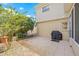 Outdoor patio with a table, a grill, mature trees and landscaping at 15034 Newport Rd, Clearwater, FL 33764