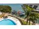 Aerial view of a community pool and private boat slips along the waterfront at 1581 Gulf Blvd # 301N, Clearwater Beach, FL 33767