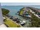 Aerial view of condo community featuring boat docks, a pool, and lush landscaping at 1581 Gulf Blvd # 301N, Clearwater Beach, FL 33767