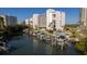 Scenic aerial view showcasing the condo building, boat docks, and community pool by the water at 1581 Gulf Blvd # 301N, Clearwater Beach, FL 33767