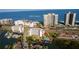 Aerial view of Gulf of America with boat docks, swimming pool, beach access, and buildings nearby at 1581 Gulf Blvd # 301N, Clearwater Beach, FL 33767