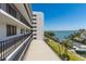 Condo building exterior and balcony overlooking the boat docks on the water at 1581 Gulf Blvd # 301N, Clearwater Beach, FL 33767