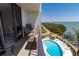 Balcony overlooking a pool, waterfront and tropical landscaping at 1581 Gulf Blvd # 301N, Clearwater Beach, FL 33767