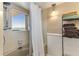 Updated bathroom featuring tiled shower and a window with a waterfront view at 1581 Gulf Blvd # 301N, Clearwater Beach, FL 33767
