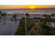 Sunset over the beach with palm trees, lush landscaping, walking paths, and ocean views at 1581 Gulf Blvd # 301N, Clearwater Beach, FL 33767