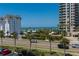 Scenic street view of lush landscaping across the street from the beautiful beach at 1581 Gulf Blvd # 301N, Clearwater Beach, FL 33767