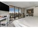 Bedroom features waterfront views from an enclosed balcony, a desk area, and an ensuite bath at 1581 Gulf Blvd # 301N, Clearwater Beach, FL 33767