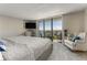 Bright bedroom featuring a large window offering waterfront views, and a cozy seating area at 1581 Gulf Blvd # 301N, Clearwater Beach, FL 33767