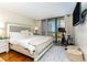 Bright bedroom with a large window and balcony access, offering ocean views at 1581 Gulf Blvd # 301N, Clearwater Beach, FL 33767