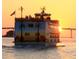 The Calypso Queen ship featuring sunset and palm tree details with orange sunset in the background at 1581 Gulf Blvd # 301N, Clearwater Beach, FL 33767