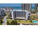 A beautiful condo building overlooking manicured grounds, a pool, and a boat dock at 1581 Gulf Blvd # 301N, Clearwater Beach, FL 33767