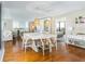 Bright dining room featuring hardwood floors, a modern white table, woven chairs and stylish pendant lighting at 1581 Gulf Blvd # 301N, Clearwater Beach, FL 33767