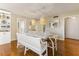 Elegant dining room with hardwood floors, stylish lighting, and a charming bench at 1581 Gulf Blvd # 301N, Clearwater Beach, FL 33767