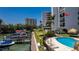 Condo building with boat docks and a pool near the waterfront, perfect for relaxation and recreation at 1581 Gulf Blvd # 301N, Clearwater Beach, FL 33767