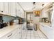 Bright, white kitchen with stainless steel appliances, sleek countertops, and balcony access at 1581 Gulf Blvd # 301N, Clearwater Beach, FL 33767