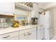Bright kitchen with white cabinets and countertops, and tile backsplash at 1581 Gulf Blvd # 301N, Clearwater Beach, FL 33767