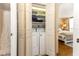 Convenient laundry closet with washer and dryer, located near the bedroom and bathroom at 1581 Gulf Blvd # 301N, Clearwater Beach, FL 33767