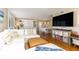 Bright open-concept living space with a large sectional, dining area, and modern entertainment center at 1581 Gulf Blvd # 301N, Clearwater Beach, FL 33767