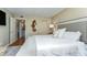 Relaxing main bedroom featuring a large bed, soft lighting, and access to ensuite bathroom at 1581 Gulf Blvd # 301N, Clearwater Beach, FL 33767
