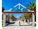 Picturesque entrance to Pier 60 with palm trees and a clear blue sky at 1581 Gulf Blvd # 301N, Clearwater Beach, FL 33767