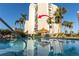 Inviting pool with a view of the condo building and tiki hut, perfect for a refreshing swim at 1581 Gulf Blvd # 301N, Clearwater Beach, FL 33767